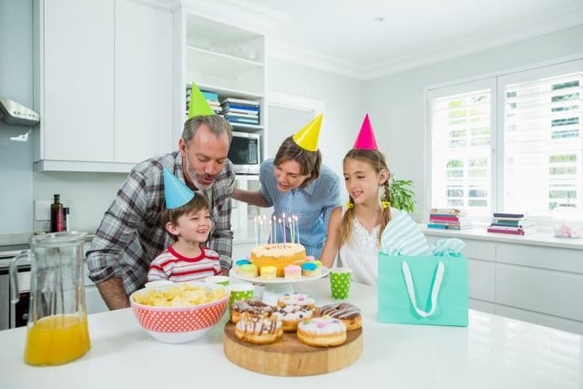 Family celebrating their sons birthday in kitchen - Download Free Stock Photos Pikwizard.com