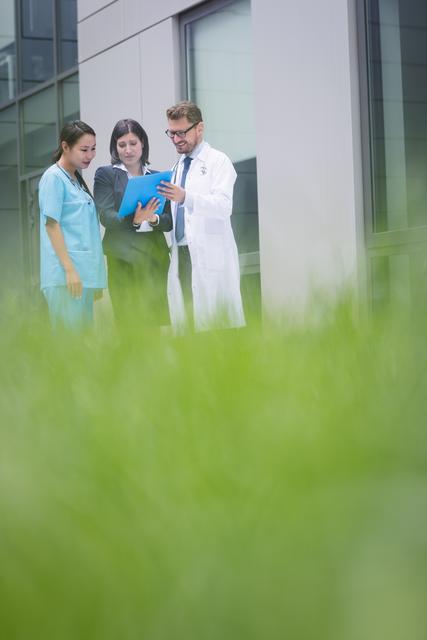 Doctors and nurse discussing over report - Download Free Stock Photos Pikwizard.com