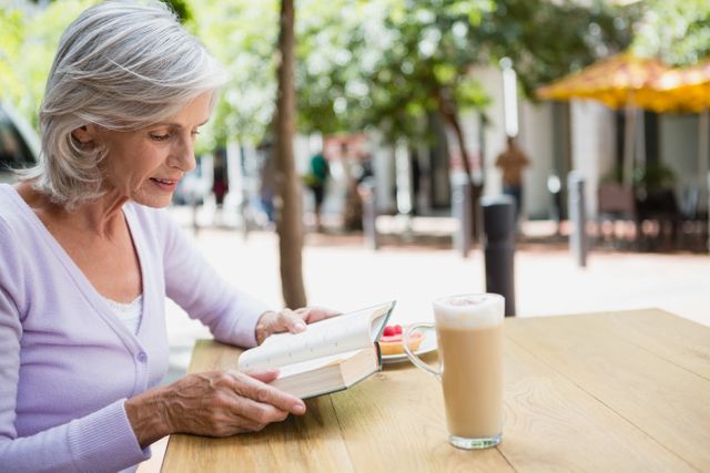 Senior woman reading a book - Download Free Stock Photos Pikwizard.com
