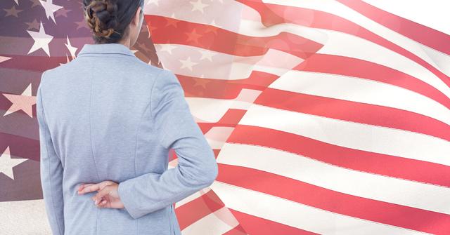 Digital composite of Rear view of businesswoman crossing fingers against American flag