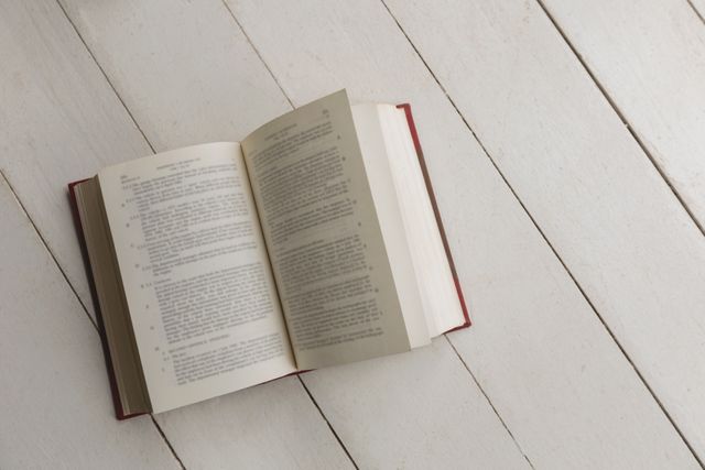 Close-up of an open book placed on the floor at home