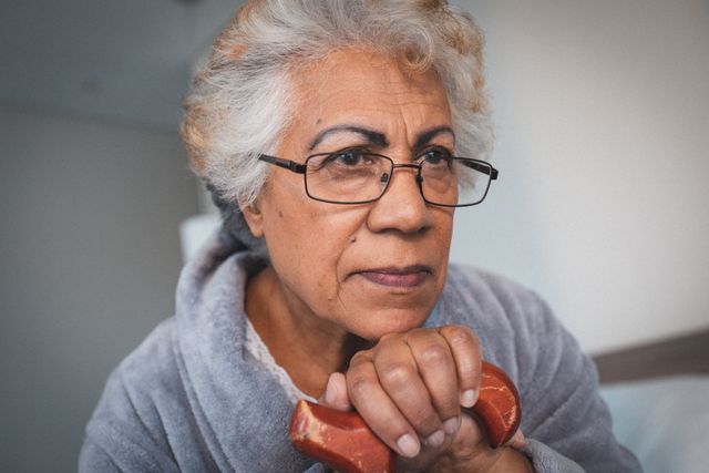 Close up of african american senior woman holding a walking stick at home - Download Free Stock Photos Pikwizard.com