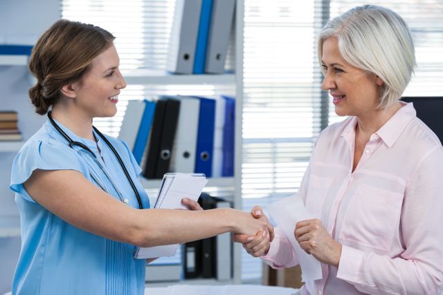 Doctor shaking hands with patient - Download Free Stock Photos Pikwizard.com