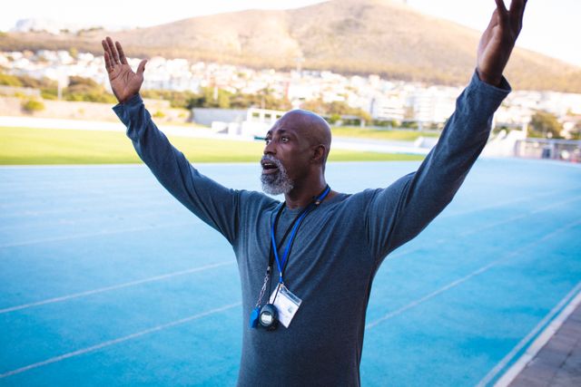 African american male coach with raised hands during training - Download Free Stock Photos Pikwizard.com