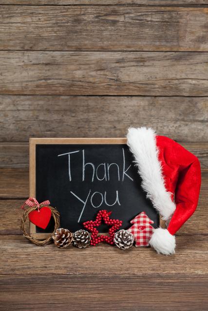 Thank you message on slate with chirstmas decorations on wooden table - Download Free Stock Photos Pikwizard.com