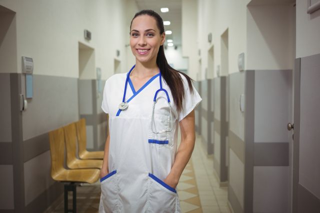 Portrait of female nurse standing in corridor - Download Free Stock Photos Pikwizard.com