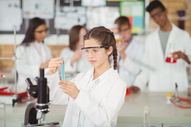 Attentive schoolgirl doing a chemical experiment in laboratory - Download Free Stock Photos Pikwizard.com