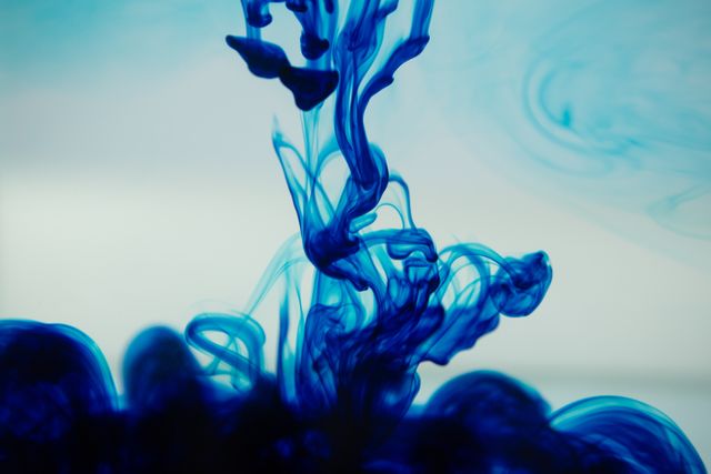 Close-up of blue ink spreading in the water