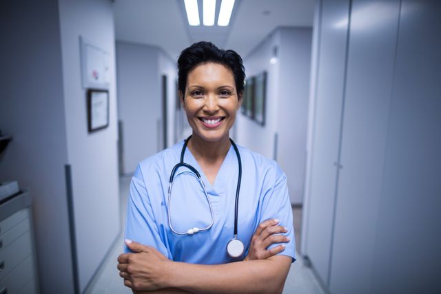 Portrait of female nurse standing in corridor - Download Free Stock Photos Pikwizard.com