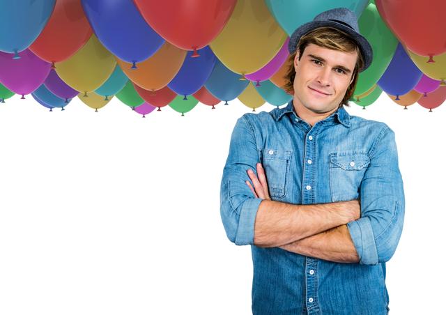 Trendy man with arms folded in front of balloons and white space - Download Free Stock Photos Pikwizard.com