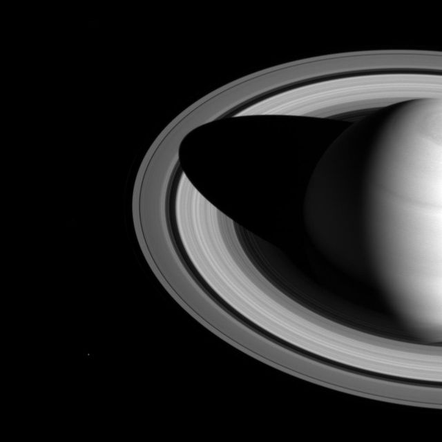 The shadow of Saturn on the rings, which stretched across all of the rings earlier in Cassini's mission (see PIA08362), now barely makes it past the Cassini division.  The changing length of the shadow marks the passing of the seasons on Saturn. As the planet nears its northern-hemisphere solstice in May 2017, the shadow will get even shorter. At solstice, the shadow's edge will be about 28,000 miles (45,000 kilometers) from the planet's surface, barely making it past the middle of the B ring.  The moon Mimas is a few pixels wide, near the lower left in this image.  This view looks toward the sunlit side of the rings from about 35 degrees above the ring plane. The image was taken in visible light with the Cassini spacecraft wide-angle camera on May 21, 2016.  The view was obtained at a distance of approximately 2.0 million miles (3.2 million kilometers) from Saturn. Image scale is 120 miles (190 kilometers) per pixel.  http://photojournal.jpl.nasa.gov/catalog/PIA20494