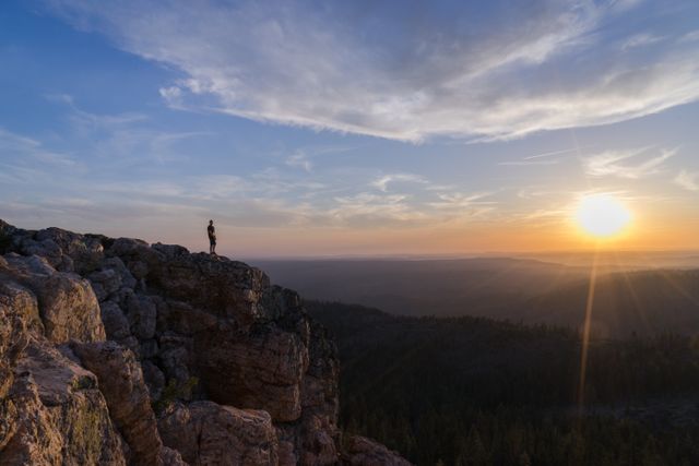 Man Standing on Cliff Watching Sunrise - Download Free Stock Photos Pikwizard.com