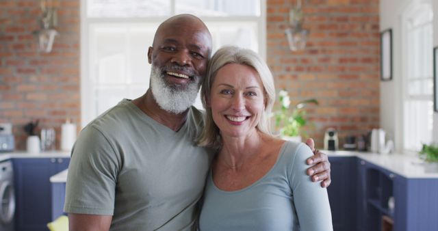 Portrait of mixed race senior couple smiling at home. retirement senior couple lifestyle living concept
