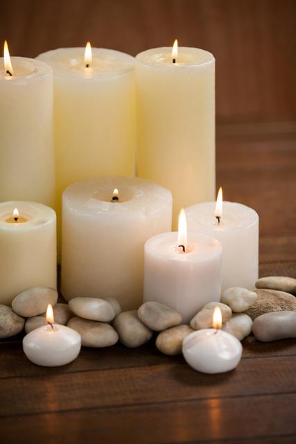 Close- up of white candles and pebbles stone on wood - Download Free Stock Photos Pikwizard.com