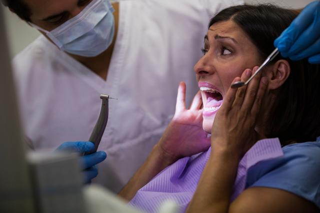 Female patient scared during a dental check-up - Download Free Stock Photos Pikwizard.com