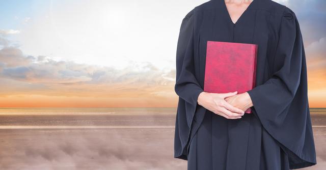 Judge holding book in front of sky - Download Free Stock Photos Pikwizard.com