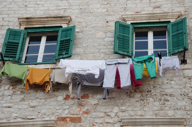 Clothes Drying Against Brick Wall - Download Free Stock Photos Pikwizard.com