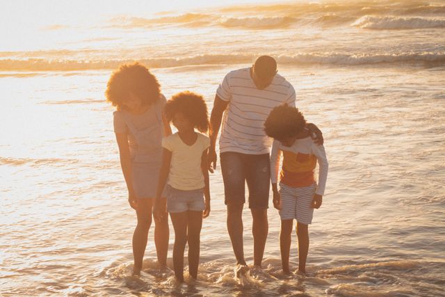 Happy african american parents and children standing on the seashore - Download Free Stock Photos Pikwizard.com