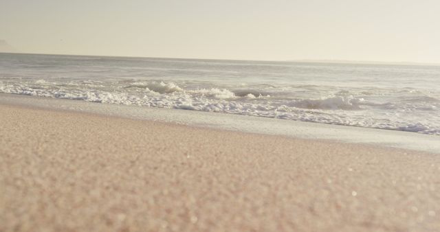Calm sea waves lapping on empty beach at sundown - Download Free Stock Photos Pikwizard.com