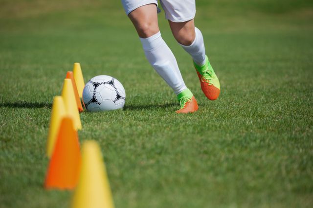 Soccer player dribbling through cones - Download Free Stock Photos Pikwizard.com