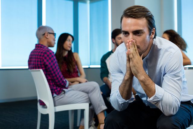 Man crying while creative business team in background - Download Free Stock Photos Pikwizard.com