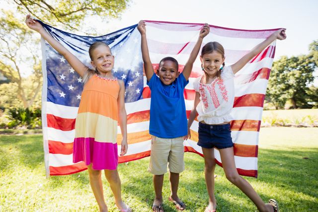  Happy children showing usa flag at park