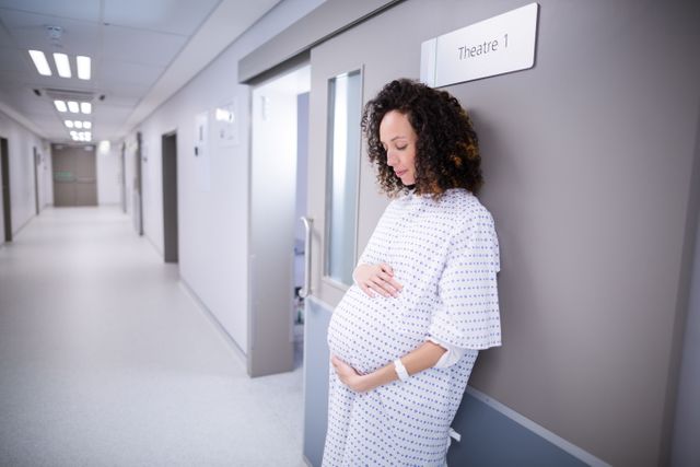 Pregnant woman standing in corridor - Download Free Stock Photos Pikwizard.com