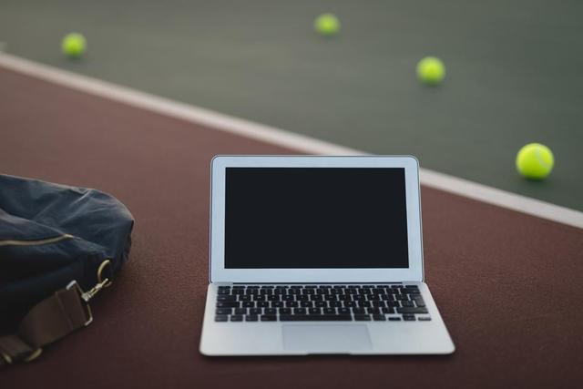 Laptop, bag and tennis ball in ground - Download Free Stock Photos Pikwizard.com