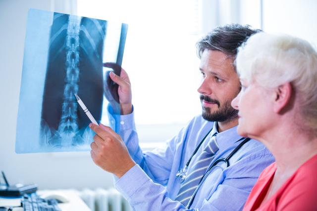 Doctor discussing x-ray with patient - Download Free Stock Photos Pikwizard.com