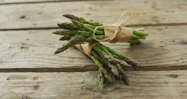 Image of two fresh asparagus bundles on wooden background - Download Free Stock Photos Pikwizard.com