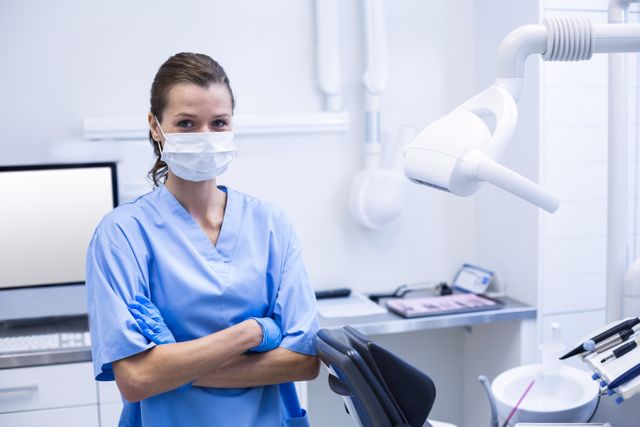 Smiling dental assistant standing with arms crossed - Download Free Stock Photos Pikwizard.com