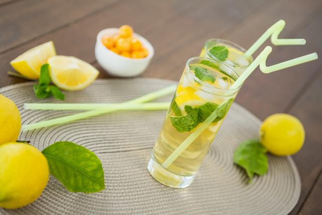 Glass of mojito cocktail, lemon and yellow cherries - Download Free Stock Photos Pikwizard.com