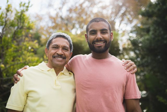 Portrait of smiling man with his father standing at park - Download Free Stock Photos Pikwizard.com