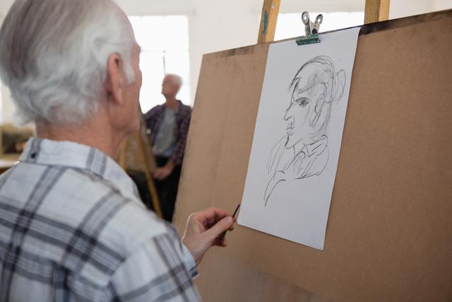 Close up of senior man drawing sketch of woman - Download Free Stock Photos Pikwizard.com