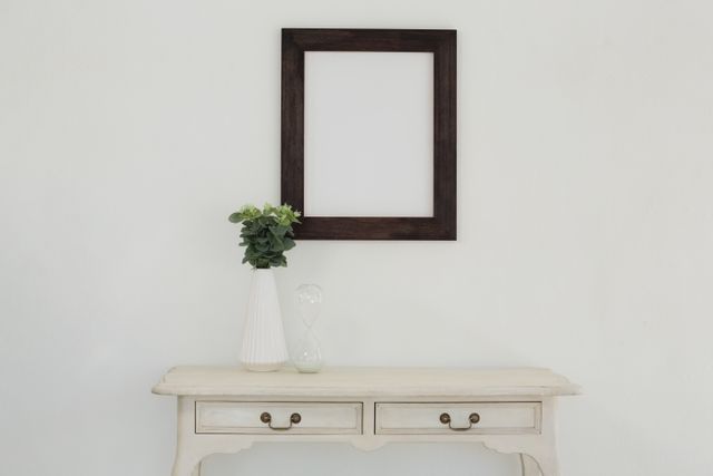 Wooden frame and vase against white wall - Download Free Stock Photos Pikwizard.com
