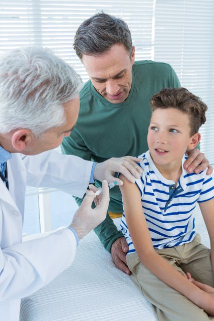 Doctor giving an injection to the patient - Download Free Stock Photos Pikwizard.com