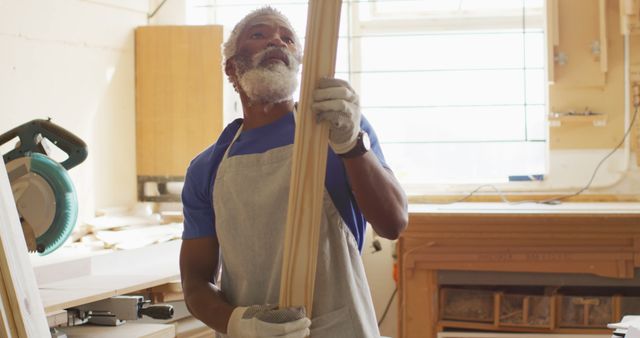 Young carpenter african american man looking and choosing wood and