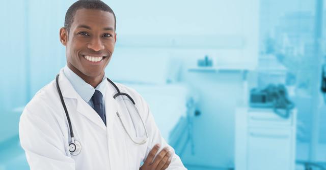Doctor standing with arms crossed at clinic - Download Free Stock Photos Pikwizard.com