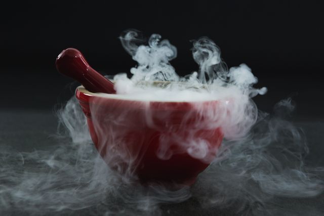 Dry ice smoke in bowl on black background - Download Free Stock Photos Pikwizard.com