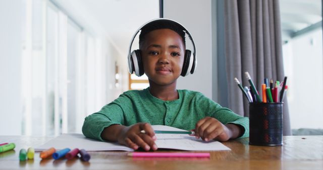 Portrait of african american boy wearing headphones talking looking at the camera - Download Free Stock Photos Pikwizard.com