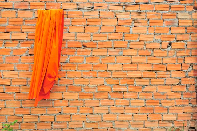 a wall with an orange cloth hanging on it - Download Free Stock Photos Pikwizard.com