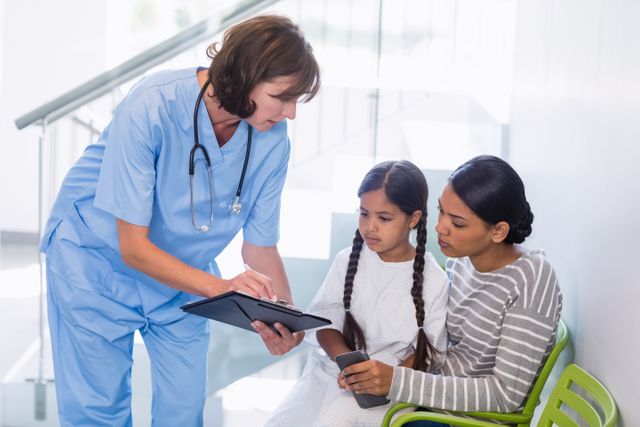 Nurse discussing a medical report with woman and patient - Download Free Stock Photos Pikwizard.com