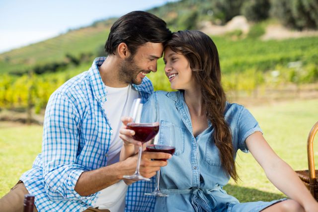 Romantic couple holding red wine glasses - Download Free Stock Photos Pikwizard.com