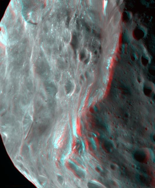 Phoebe violent, cratered past is evident in this 3D image of the tiny moon captured by NASA Cassini spacecraft. 3D glasses are necessary to view this image.