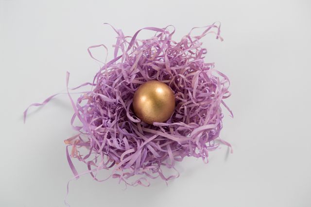 Golden Easter egg in the paper nest - Download Free Stock Photos Pikwizard.com