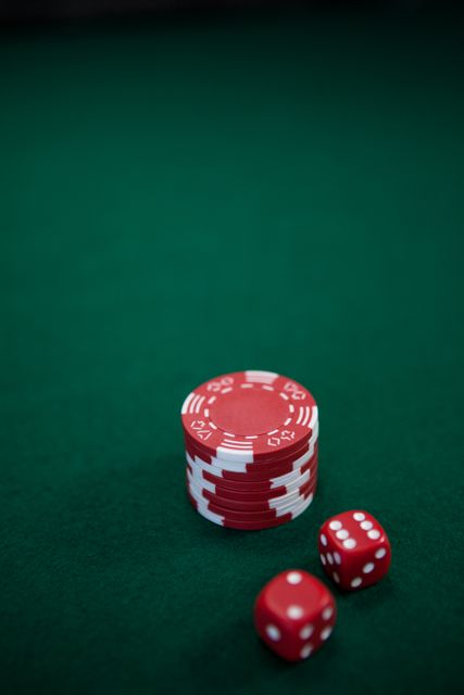 Pairs of dice and casino chips on poker table - Download Free Stock Photos Pikwizard.com