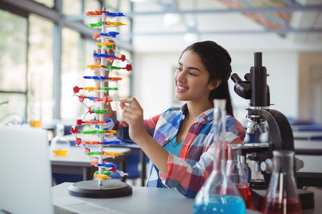 Attentive schoolgirl experimenting molecule model in laboratory - Download Free Stock Photos Pikwizard.com