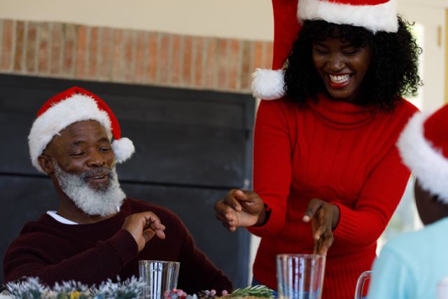 Front view of an old african-american man with a woman standing beside him happily enjoying christma - Download Free Stock Photos Pikwizard.com