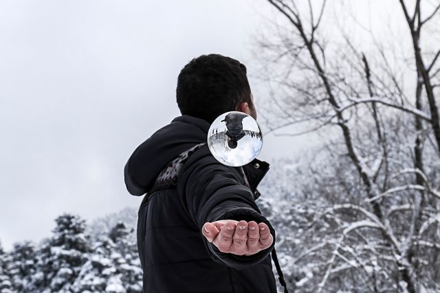 a man holding a snow globe - Download Free Stock Photos Pikwizard.com