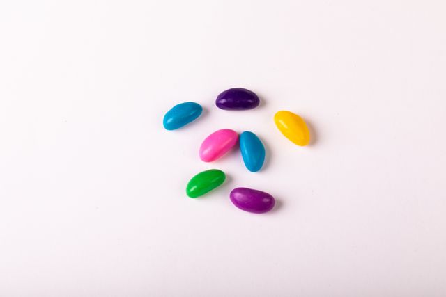 Directly above shot of colorful candies on white background, copy space - Download Free Stock Photos Pikwizard.com